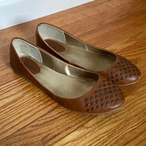 Brown flats with gold accents